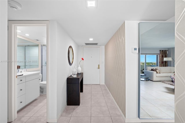 hall featuring light tile patterned floors