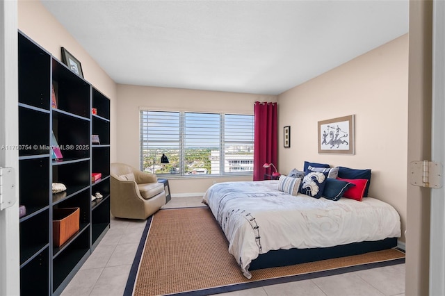 bedroom with light tile patterned floors