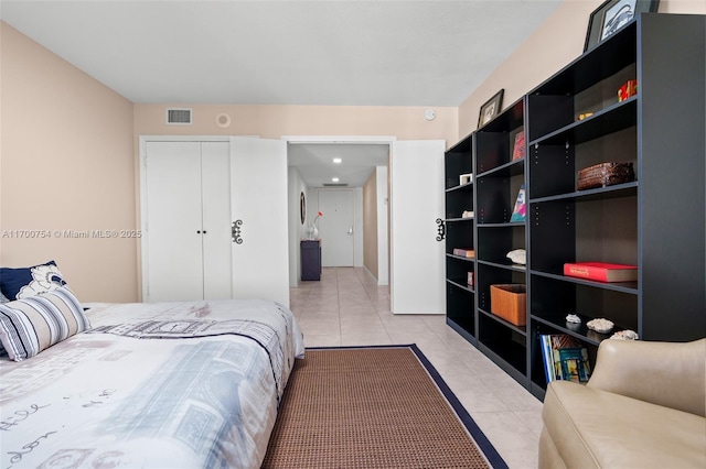 tiled bedroom with a closet