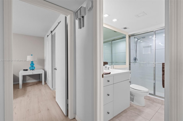 bathroom with toilet, tile patterned flooring, an enclosed shower, and vanity