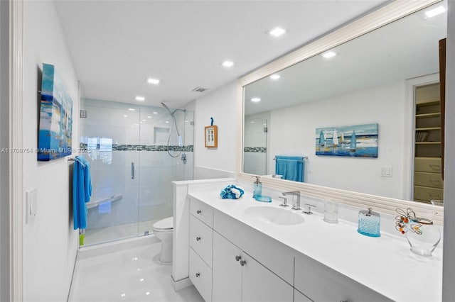 bathroom with vanity, tile patterned floors, a shower with shower door, and toilet