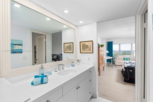 bathroom with hardwood / wood-style floors and vanity