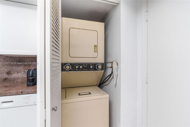 laundry area featuring stacked washer / drying machine