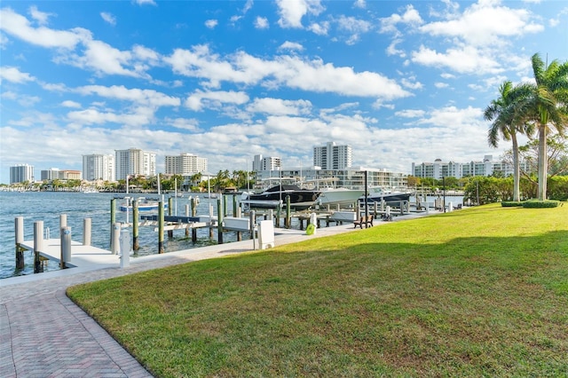 dock area with a lawn and a water view