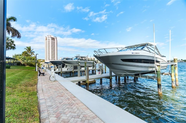 view of dock featuring a water view and a lawn