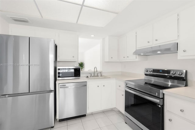 kitchen featuring sink, white cabinets, stainless steel appliances, and light tile patterned floors