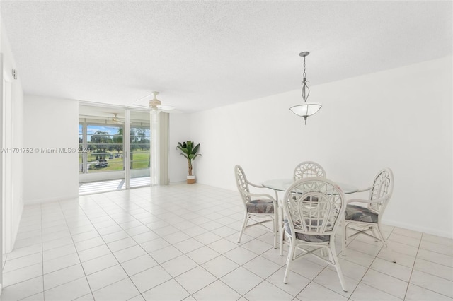 unfurnished dining area featuring light tile patterned floors, a textured ceiling, and ceiling fan