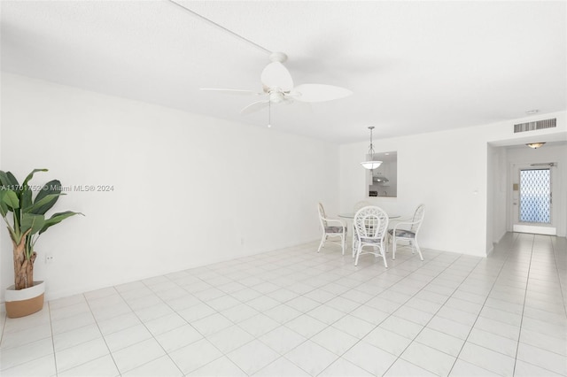 dining space featuring ceiling fan and light tile patterned floors