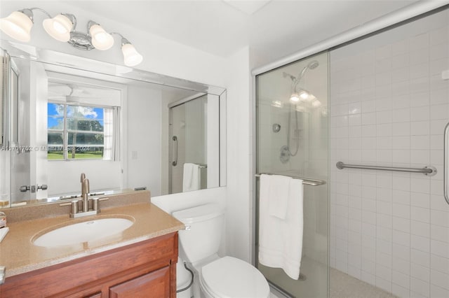 bathroom with vanity, toilet, and walk in shower