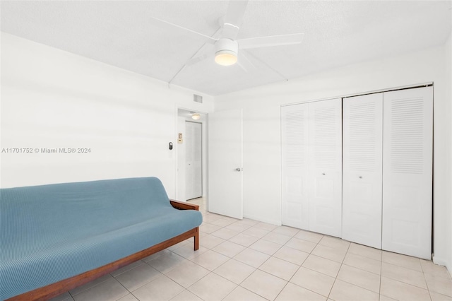 sitting room with ceiling fan and light tile patterned floors