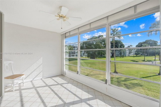 unfurnished sunroom featuring plenty of natural light and ceiling fan