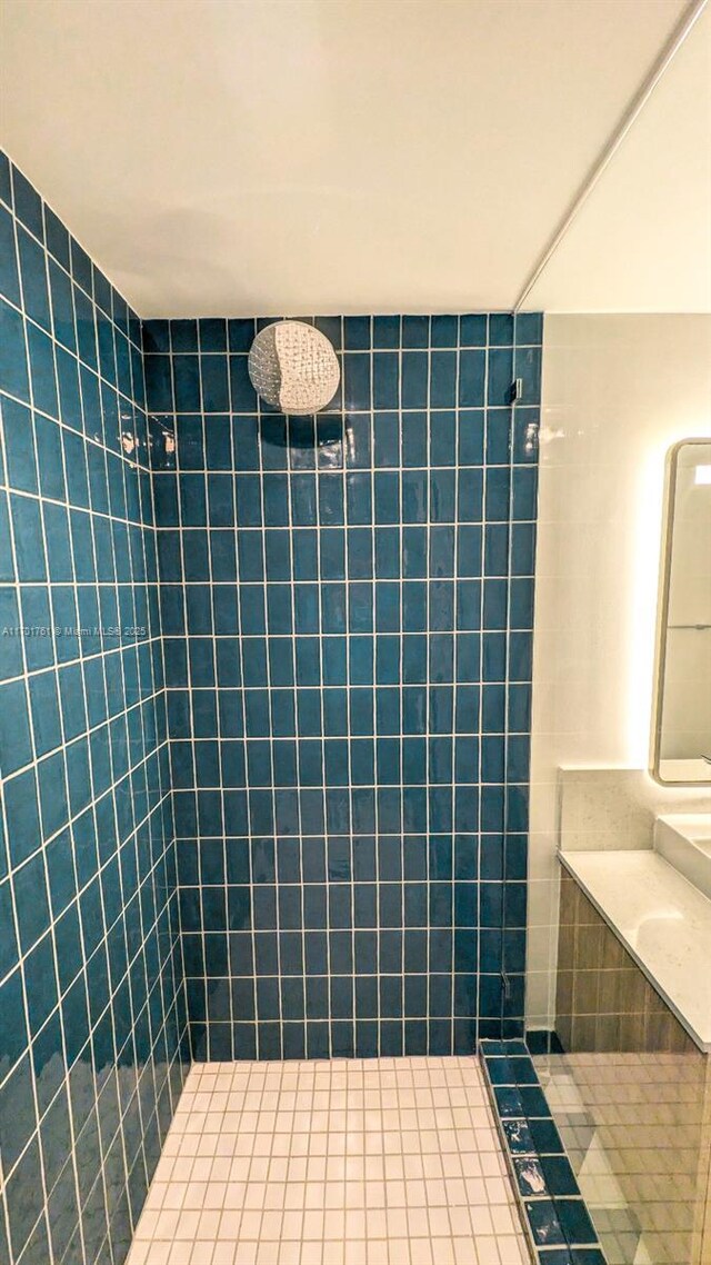 bathroom with tiled shower