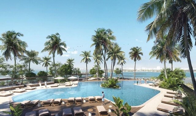 view of pool with a patio area and a water view