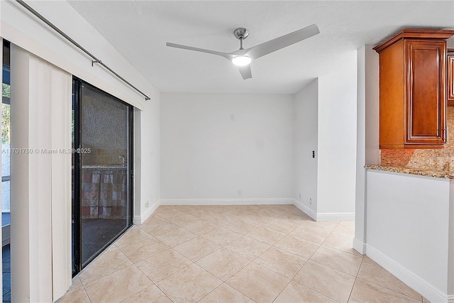 unfurnished room with ceiling fan and light tile patterned floors