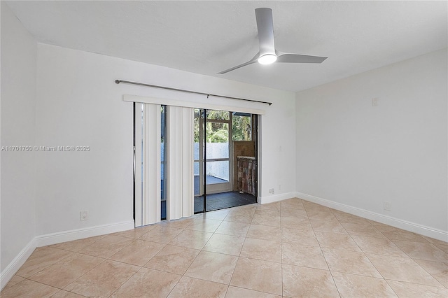 spare room featuring ceiling fan and light tile patterned floors