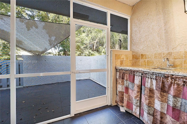 unfurnished sunroom with sink