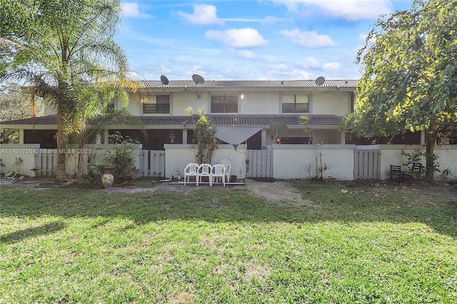 rear view of house with a yard