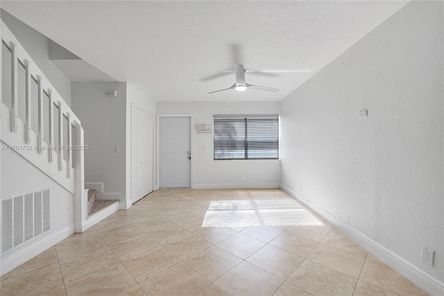 tiled empty room with ceiling fan