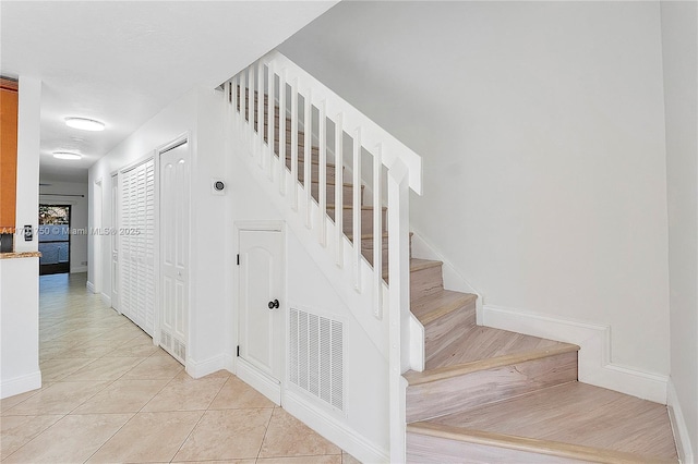 staircase with tile patterned floors