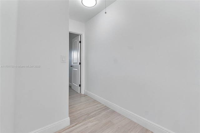 corridor with light hardwood / wood-style flooring