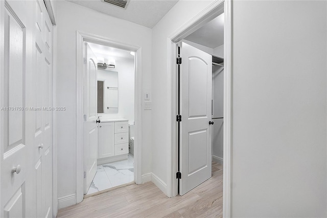 hallway with light wood-type flooring