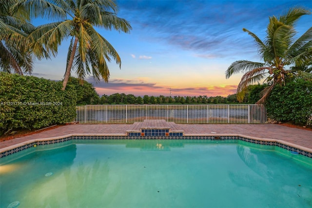 view of pool at dusk