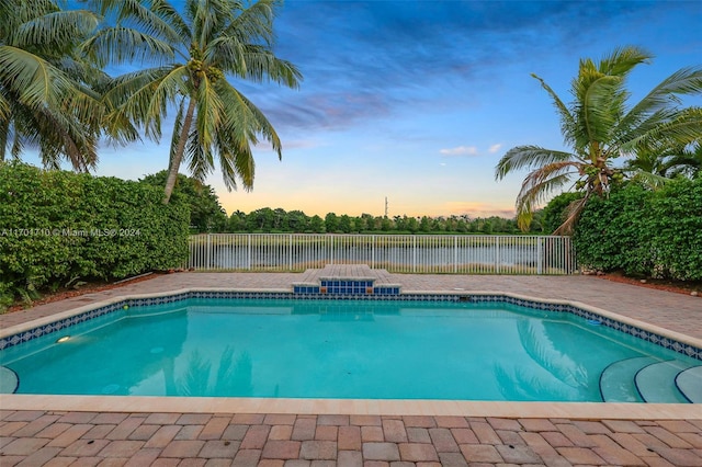 view of pool at dusk