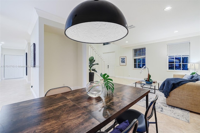 tiled dining room featuring crown molding