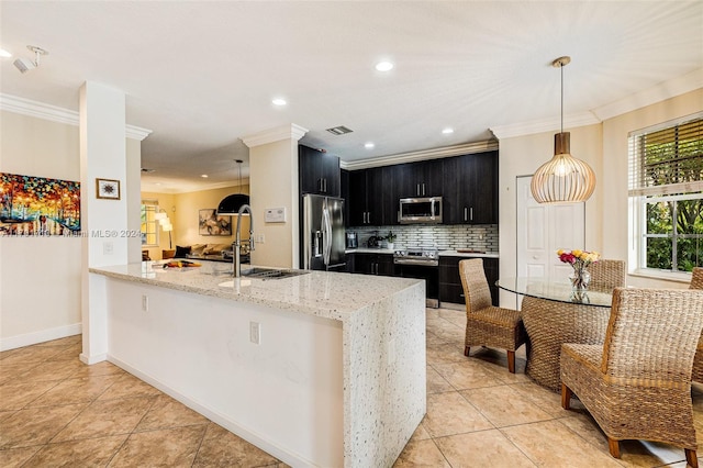 kitchen with light stone counters, stainless steel appliances, kitchen peninsula, and hanging light fixtures