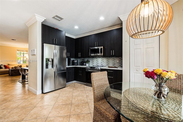 kitchen featuring light tile patterned floors, appliances with stainless steel finishes, ornamental molding, and tasteful backsplash