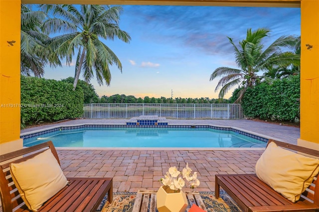 view of pool at dusk