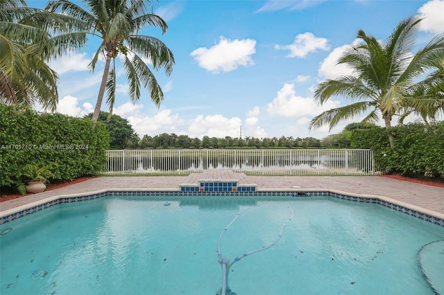 view of swimming pool with a water view