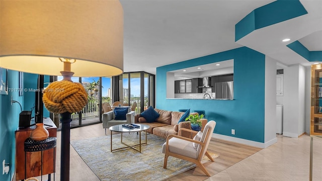 living room with expansive windows and light hardwood / wood-style floors