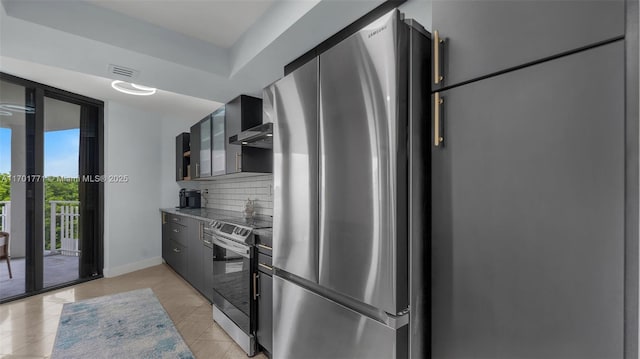 kitchen with decorative backsplash, light tile patterned flooring, wall chimney exhaust hood, and appliances with stainless steel finishes