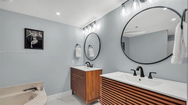 bathroom featuring vanity and a washtub