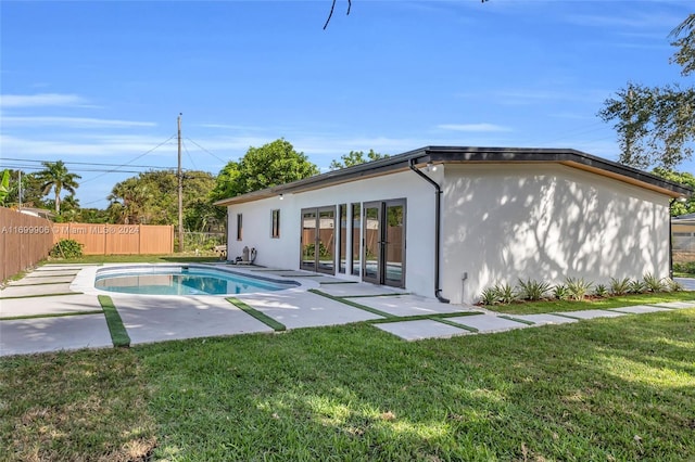 view of swimming pool featuring a patio area and a yard