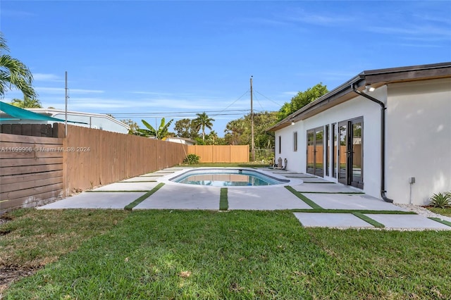 view of swimming pool featuring a yard and a patio area