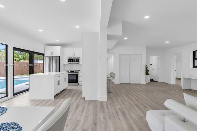 living room featuring light wood-type flooring and french doors