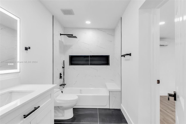 full bathroom featuring hardwood / wood-style floors, vanity, toilet, and tiled shower / bath