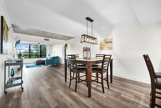 dining space with wood-type flooring