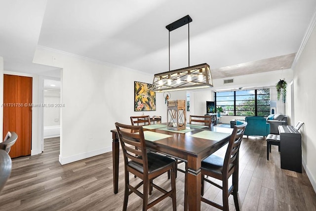 dining room featuring crown molding and hardwood / wood-style floors