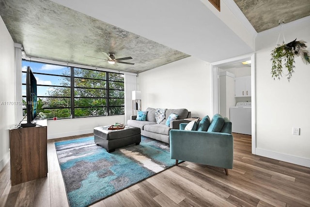 living room featuring wood-type flooring, washer / clothes dryer, and ceiling fan