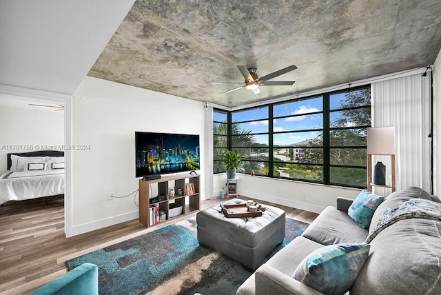 living room with hardwood / wood-style floors and ceiling fan