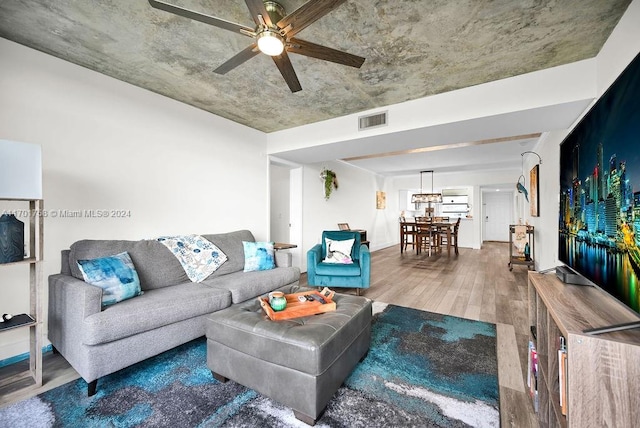 living room with hardwood / wood-style flooring and ceiling fan