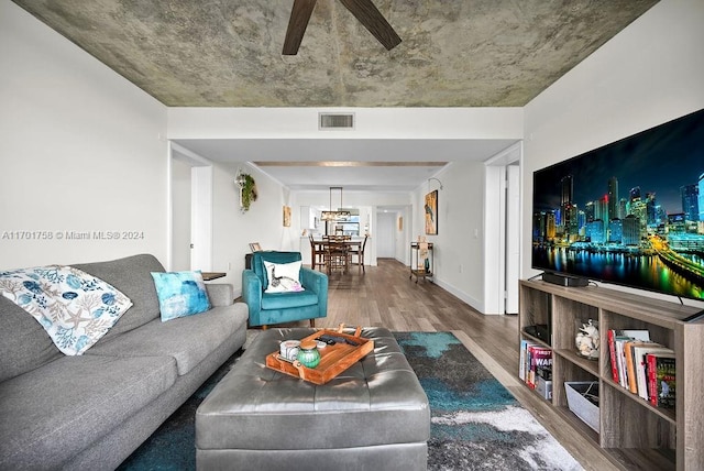 living room with hardwood / wood-style flooring and ceiling fan