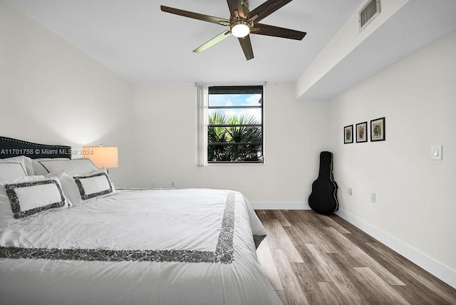 bedroom with ceiling fan and wood-type flooring