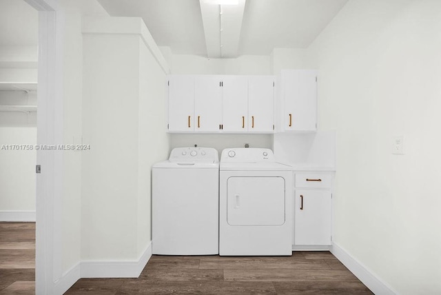 laundry area featuring hardwood / wood-style flooring, cabinets, and separate washer and dryer