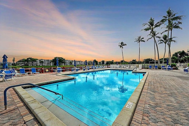 pool at dusk with a patio