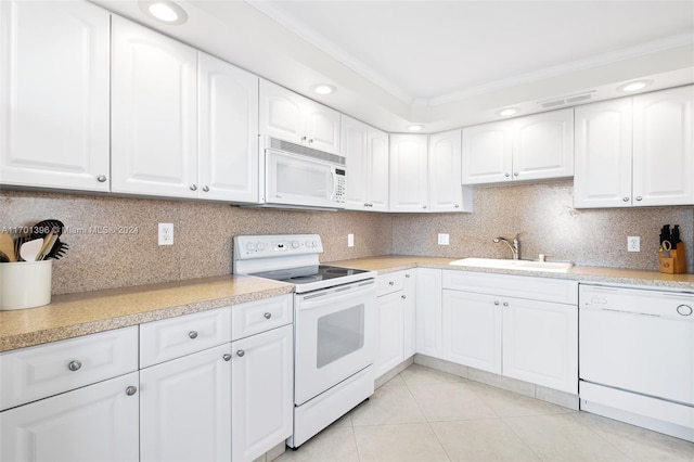 kitchen featuring white appliances, tasteful backsplash, white cabinetry, and sink