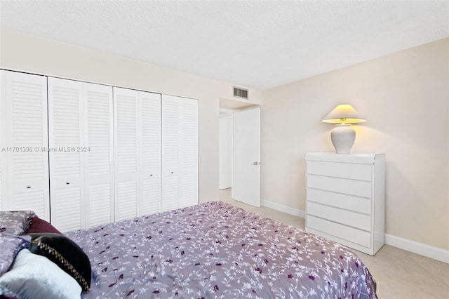 bedroom with a textured ceiling and a closet